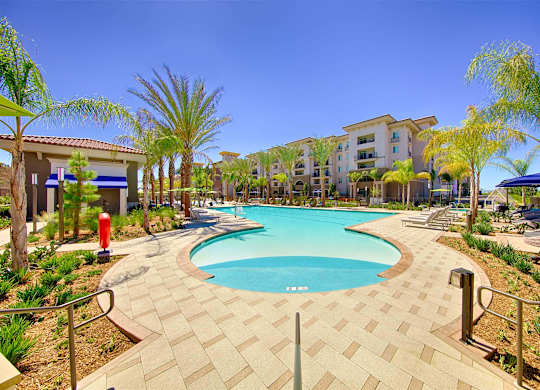 Resort style pool with cabanas and palm trees at Casa Mira View Apartments, San Diego, California