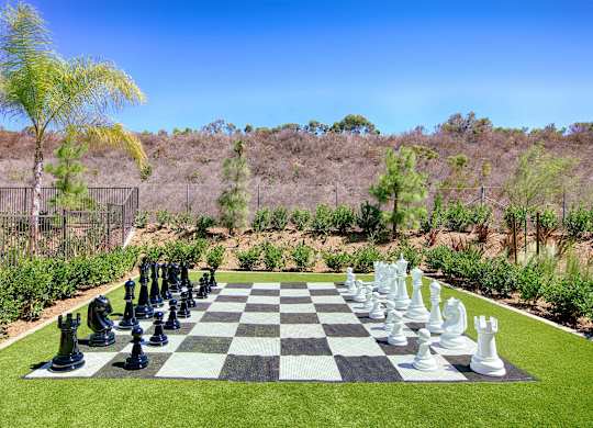 Oversized chess set on artificial turf lawn at Casa Mira View Apartments, San Diego