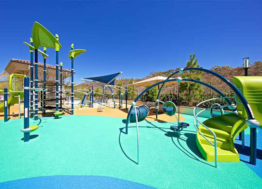 Colorful playground with slides and climbing structures at Casa Mira View Apartments, San Diego, 92126