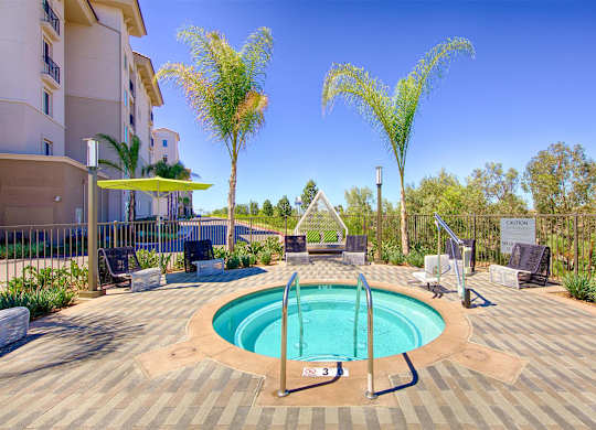 Circular spa with paver deck and palm trees at Casa Mira View Apartments, San Diego, 92126