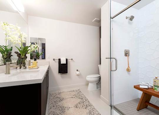 Modern bathroom with glass enclosed shower at Elements Apartments, California, 92612