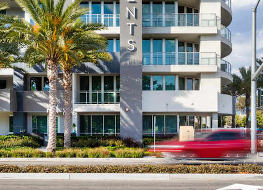 Modern apartment building exterior with vertical signage at Elements Apartments, Irvine, CA
