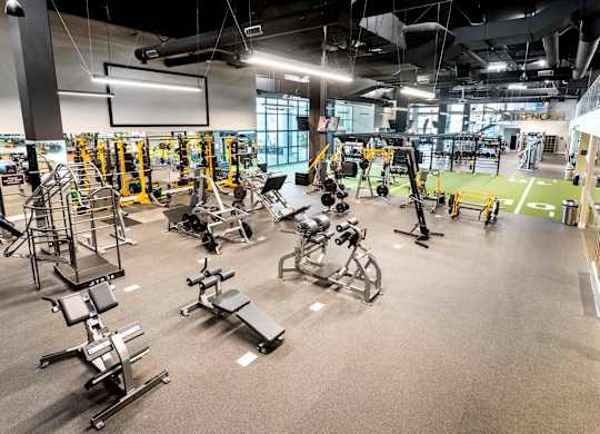 Fitness center with weightlifting equipment and turf area at Elements Apartments, Irvine, CA
