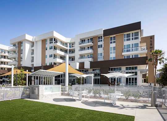 Outdoor recreation area with shade sails and seating at Elements Apartments, California, 92612