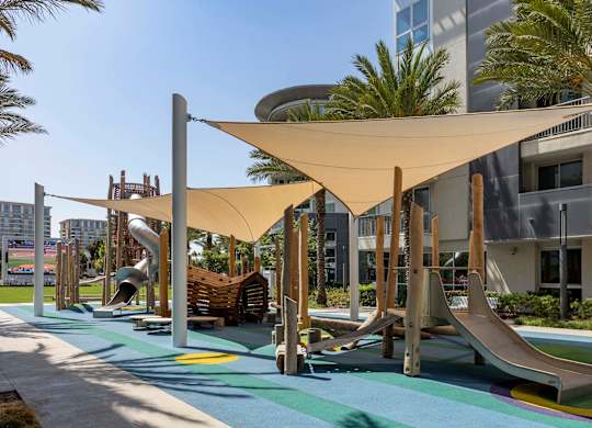 Playground with slides and shade sails at Elements Apartments, California