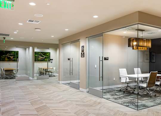 Glass walled conference rooms with herringbone flooring at Elements Apartments, Irvine, California