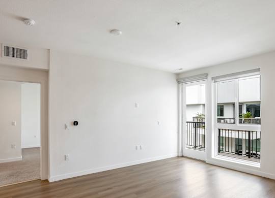 Bright living space with hardwood flooring and windows at Elements Apartments, Irvine, 92612