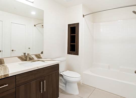 Bathroom with dual sink vanity and tub shower combo at Elements Apartments, California, 92612