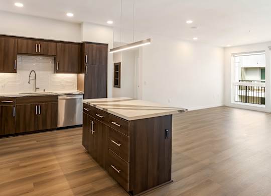 Open concept kitchen with island and pendant lighting at Elements Apartments, Irvine, CA