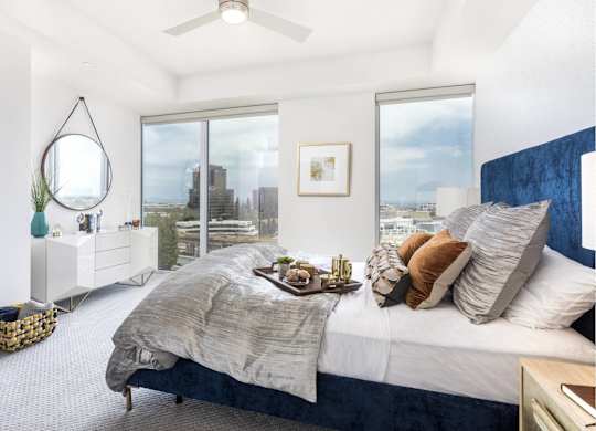 Bright bedroom with city views and modern decor at LUX by Garden* Apartments, California