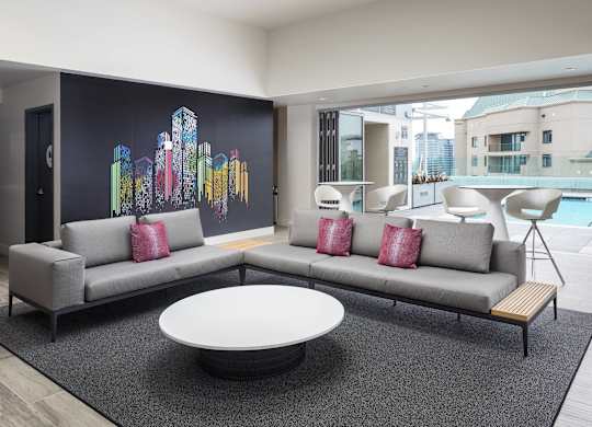 Poolside lounge area with modern sectional seating at LUX by Garden* Apartments, San Diego, 92122