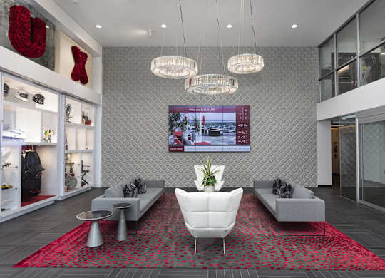 Lobby seating area with crystal chandeliers and display shelving at LUX by Garden* Apartments, California, 92122