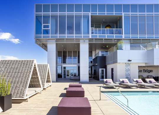 Rooftop pool deck with cabanas and lounge chairs at LUX by Garden* Apartments, California, 92122