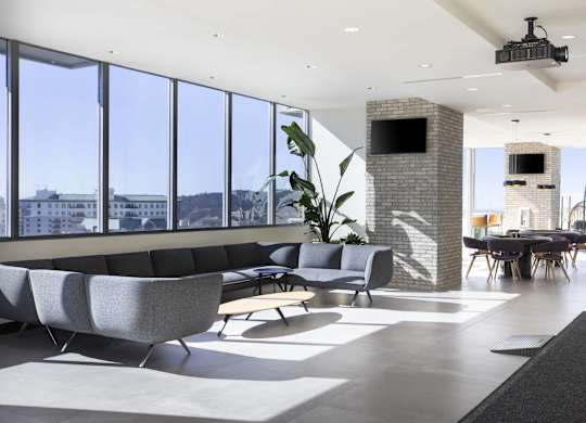 Open concept lounge with floor to ceiling windows at LUX by Garden* Apartments, San Diego, California