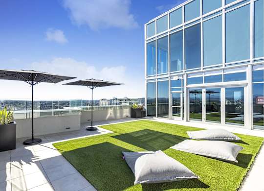 Rooftop terrace with artificial turf and floor cushions at LUX by Garden* Apartments, California, 92122