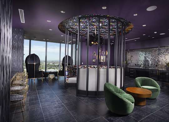 Bar area with colorful mosaic canopy and lounge seating at LUX by Garden* Apartments, San Diego, CA
