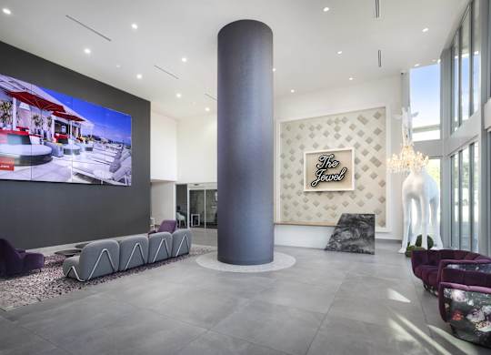 Modern lobby with video wall and sculptural seating at LUX by Garden* Apartments, San Diego, 92122