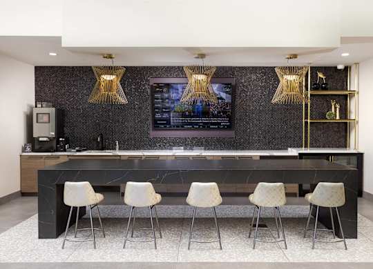 Community bar with marble countertop and bar stools at LUX by Garden* Apartments, California, 92122
