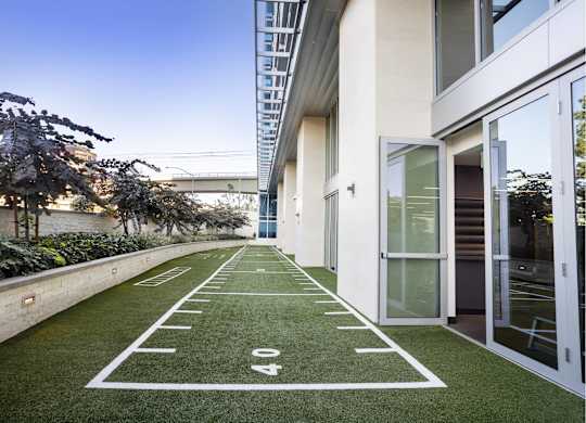 Artificial turf recreation area with yard line markings at LUX by Garden* Apartments, San Diego, CA