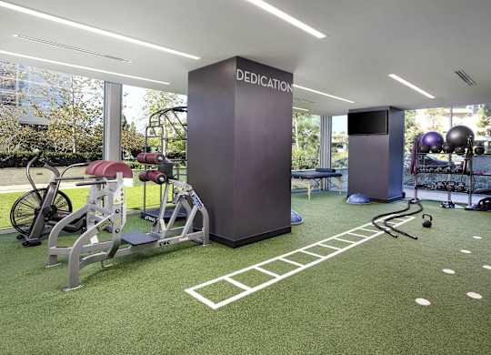 Fitness center with turf training area at LUX by Garden* Apartments, California