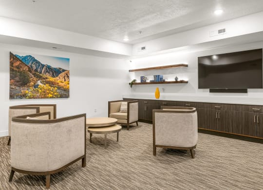 a resident clubhouse with a large tv and chairs