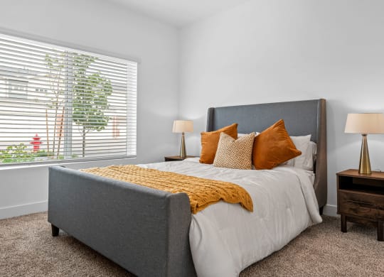 a bedroom with a bed and two night stands with lamps