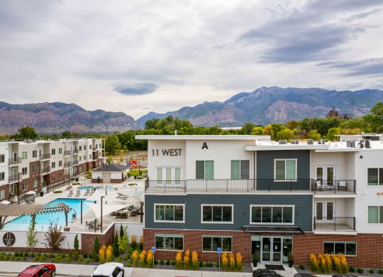 an aerial view of the in west apartments with a pool and mountains in the background