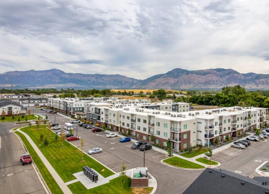 an aerial view of an apartment complex with a mountain range in the background