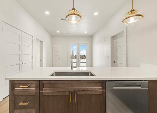 A modern kitchen with a large island and stainless steel appliances.