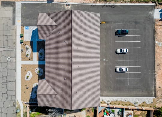 a house with a brown roof and a parking lot