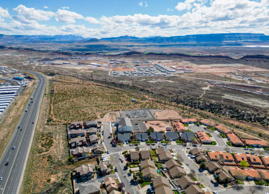 an aerial view of a city with a highway and residential neighborhoods