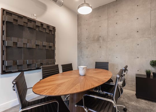 a meeting room with a wooden table and chairs