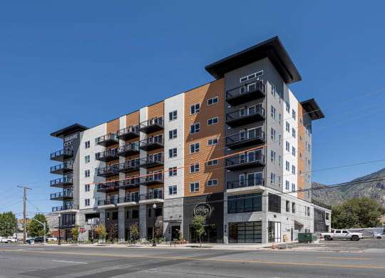 a large apartment building on the corner of a city street
