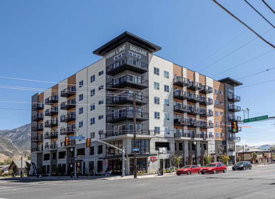 a large apartment building on the corner of a city street