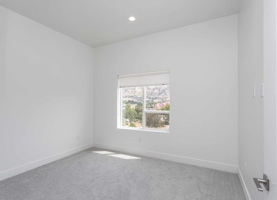 a living room with a window and white walls