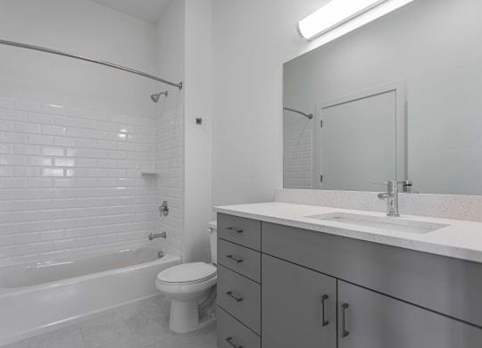 an empty bathroom with a sink toilet and shower