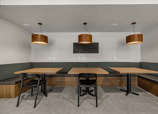 A modern dining area with a long table and chairs.