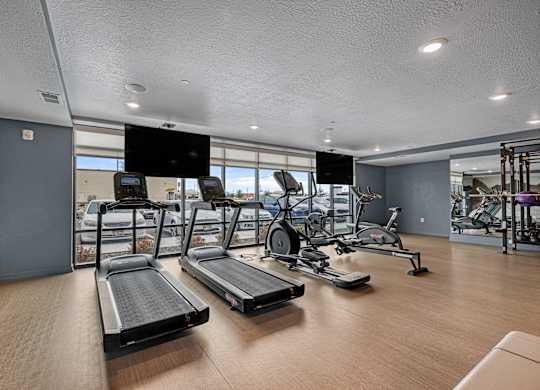 A gym with treadmills and exercise equipment.