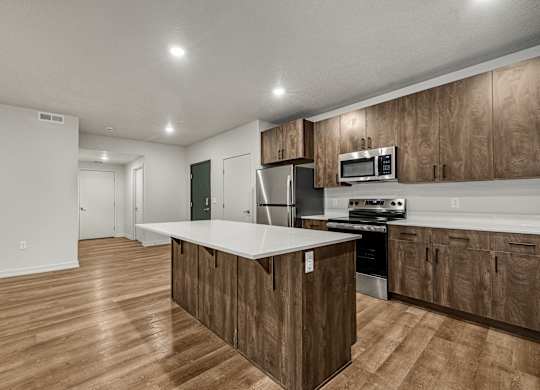 A kitchen with wooden cabinets and a white countertop.