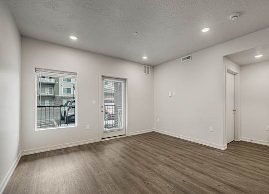 A room with a window and sliding glass doors.