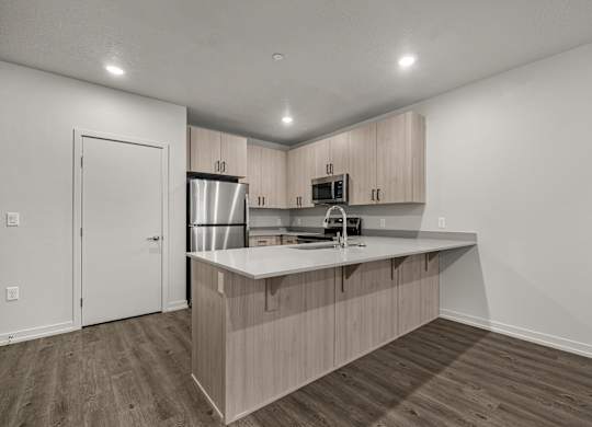 A kitchen with wooden cabinets and a white countertop.
