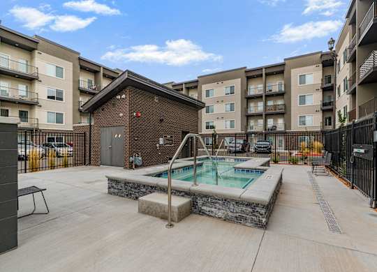 A pool in a courtyard surrounded by buildings.