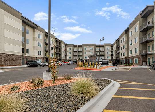 A parking lot in front of apartment buildings.