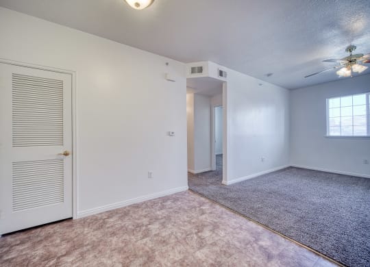 a bedroom with a ceiling fan and carpet
