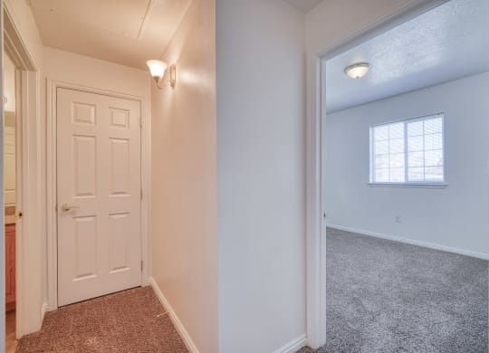 a bedroom with a door and a window