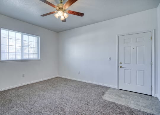 a bedroom with a ceiling fan and a window