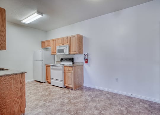 a kitchen with white appliances and wooden cabinets