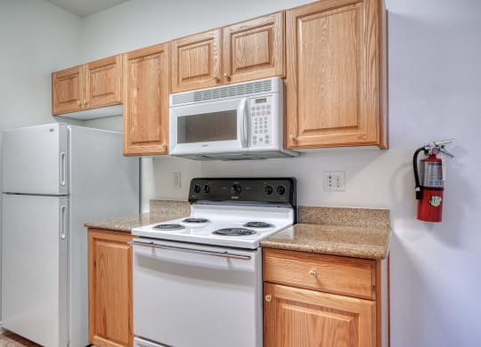 a kitchen with white appliances and wooden cabinets
