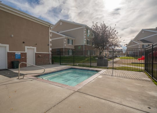 a pool at the whispering winds apartments in pearland, tx