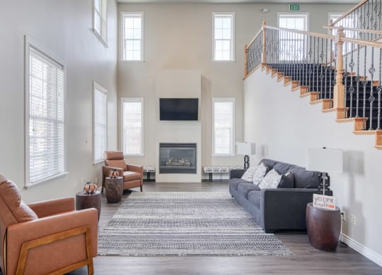 a living room with a couch chairs and a fireplace